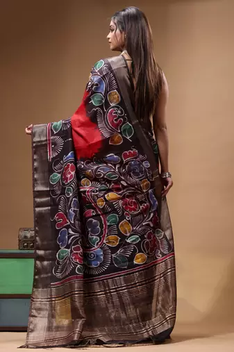 red & black hand-painted silk blend saree with multicolor floral motifs & golden zari border