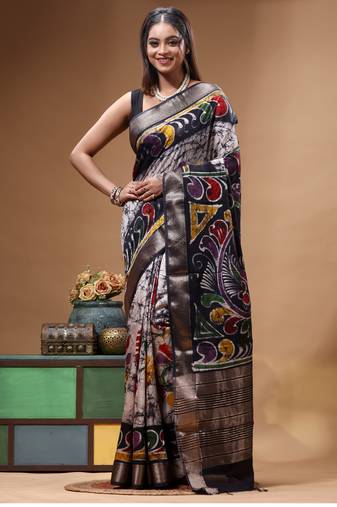 elegant black hand-painted silk blend saree with floral batik print & golden zari border