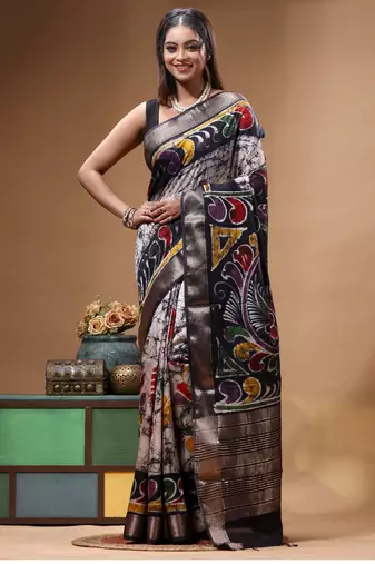 elegant black hand-painted silk blend saree with floral batik print & golden zari border