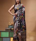 elegant black hand-painted silk blend saree with floral batik print & golden zari border