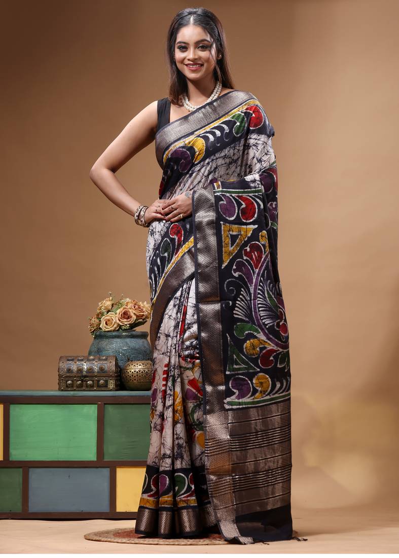 elegant black hand-painted silk blend saree with floral batik print & golden zari border