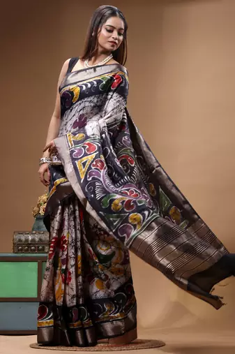 elegant black hand-painted silk blend saree with floral batik print & golden zari border