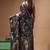 elegant black hand-painted silk blend saree with floral batik print & golden zari border