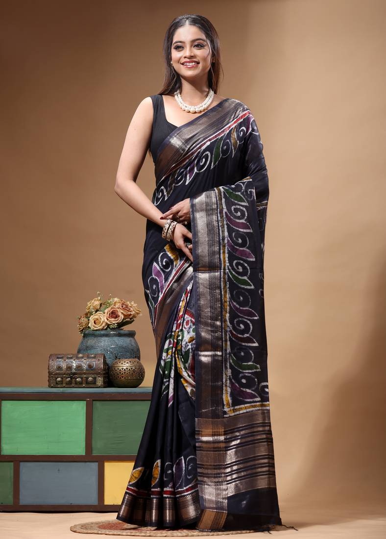 elegant black silk blend saree with hand-painted floral art & rich golden zari border