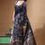elegant black silk blend saree with hand-painted floral art & rich golden zari border