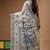off-white cotton blend saree with blue floral embroidered stitched saree