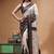 elegant off-white printed silk blend saree with red & black artistic border