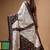 elegant off-white printed silk blend saree with red & black artistic border