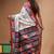 elegant off-white printed silk blend saree with red & black artistic border