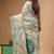 off-white cotton blend saree with teal green floral embroidered stitched saree
