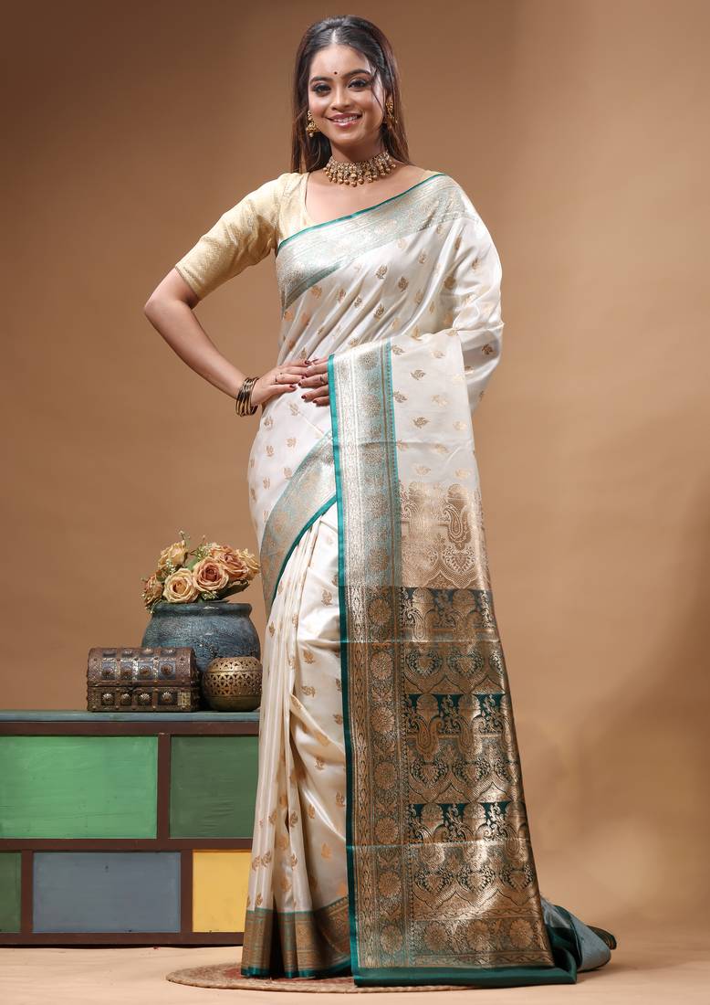 Off-white katan silk saree with gold zari woven border & green contrasting border