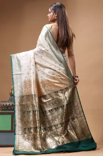 Off-white katan silk saree with gold zari woven border & green contrasting border