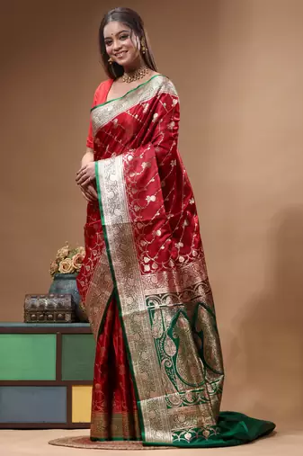 Red & green katan silk saree with zari woven border & traditional floral design