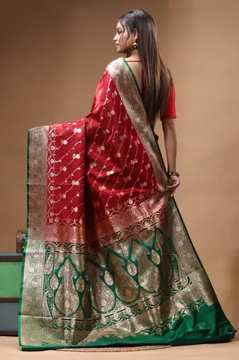 Red & green katan silk saree with zari woven border & traditional floral design