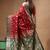 Red & green katan silk saree with zari woven border & traditional floral design
