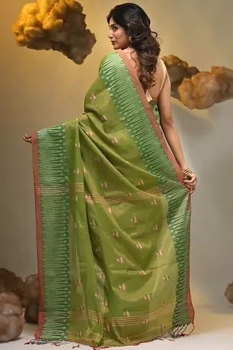 Light green coloured handwoven tissue saree with woven design