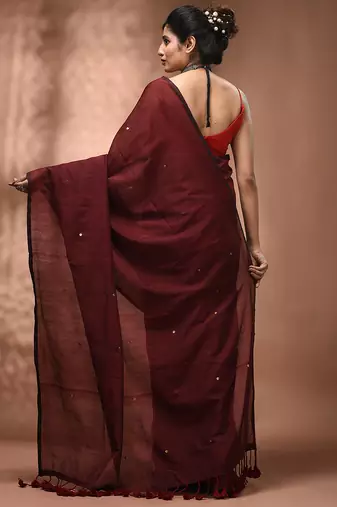 Elegant maroon cotton saree with sequin embellishments and pom pom