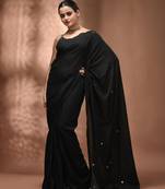 Elegant black cotton saree with sequin embellishments and pom pom