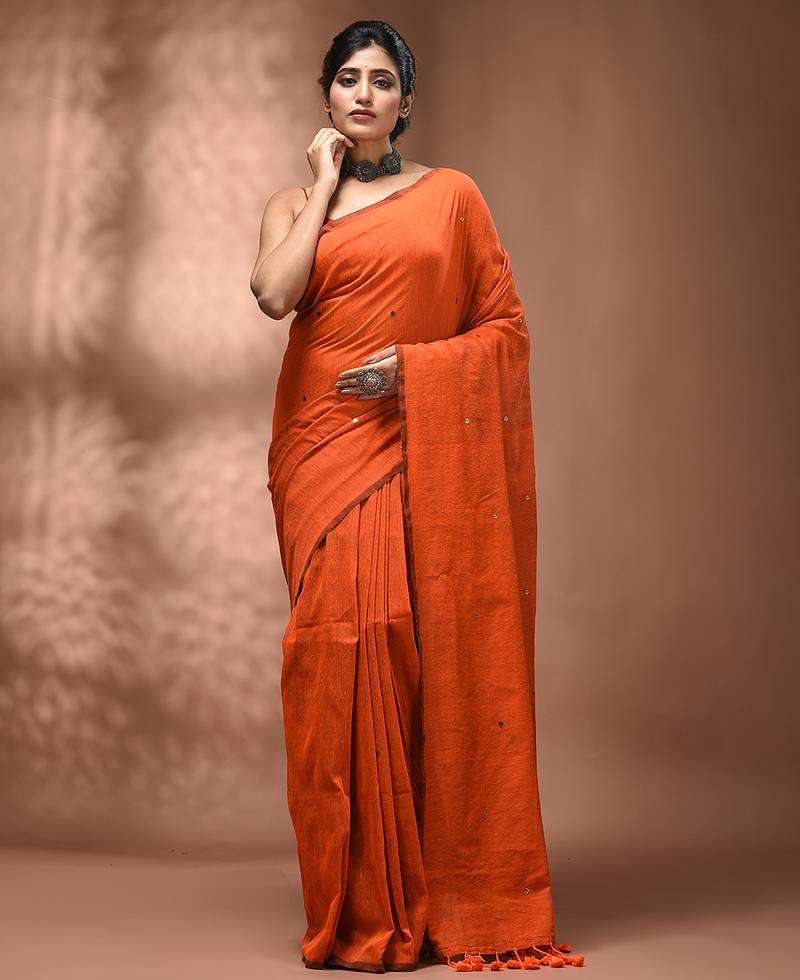 Elegant orange cotton saree with sequin embellishments and pom pom