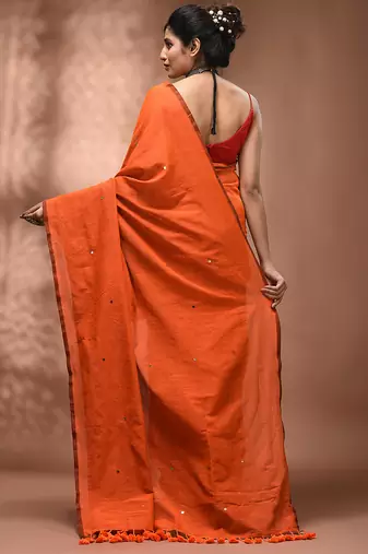 Elegant orange cotton saree with sequin embellishments and pom pom