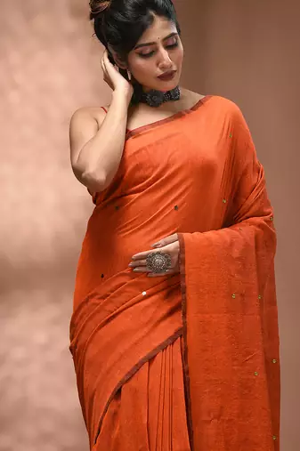 Elegant orange cotton saree with sequin embellishments and pom pom