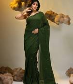 Elegant green cotton saree with sequin embellishments and pom pom