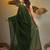 Elegant green cotton saree with sequin embellishments and pom pom