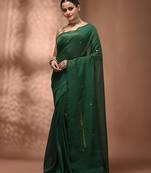 Elegant green cotton saree with sequin embellishments and pom pom