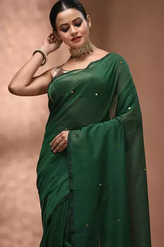 Elegant green cotton saree with sequin embellishments and pom pom
