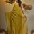 Elegant corn yellow cotton saree with sequin embellishments and pom pom