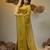 Elegant corn yellow cotton saree with sequin embellishments and pom pom