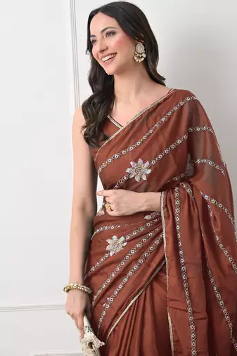rust georgette embellished lace border saree with unstitched blouse piece
