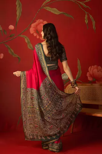 Rani silk cotton printed saree with unstitched blouse piece.