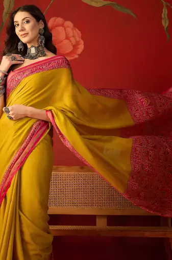 Yellow silk cotton printed saree with unstitched blouse piece.