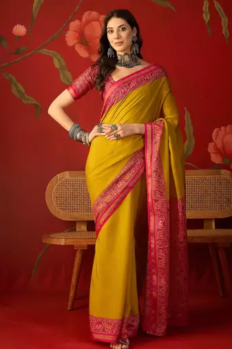 Yellow silk cotton printed saree with unstitched blouse piece.