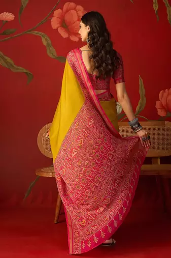 Yellow silk cotton printed saree with unstitched blouse piece.