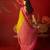 Yellow silk cotton printed saree with unstitched blouse piece.