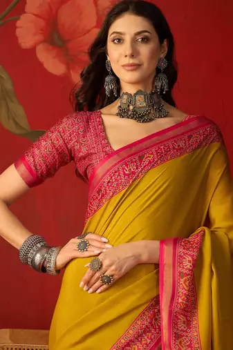 Yellow silk cotton printed saree with unstitched blouse piece.