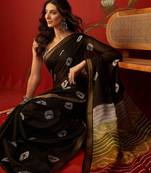Black silk cotton bandhni printed saree with unstitched blouse piece.