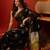 Black silk cotton bandhni printed saree with unstitched blouse piece.