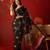 Black silk cotton bandhni printed saree with unstitched blouse piece.