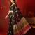 Black silk cotton bandhni printed saree with unstitched blouse piece.