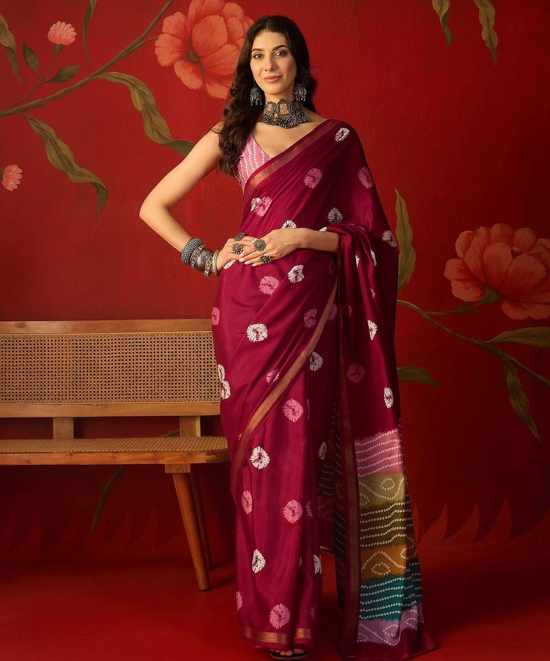 Magenta silk cotton bandhni printed saree with unstitched blouse piece.