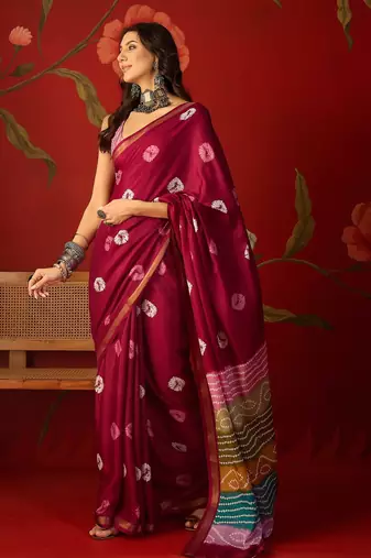 Magenta silk cotton bandhni printed saree with unstitched blouse piece.