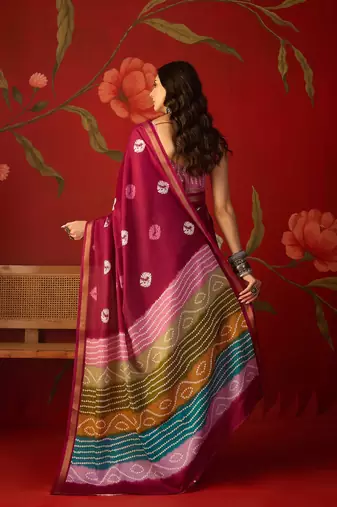 Magenta silk cotton bandhni printed saree with unstitched blouse piece.