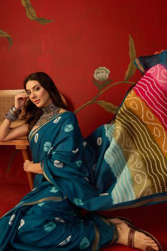 Teal silk cotton bandhni printed saree with unstitched blouse piece.