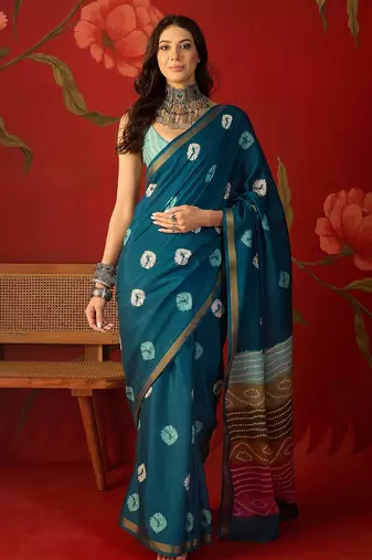 Teal silk cotton bandhni printed saree with unstitched blouse piece.