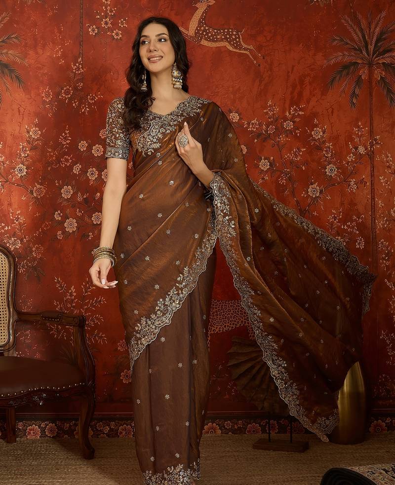 Brown tissue satin embroidered saree with unstitched blouse piece.