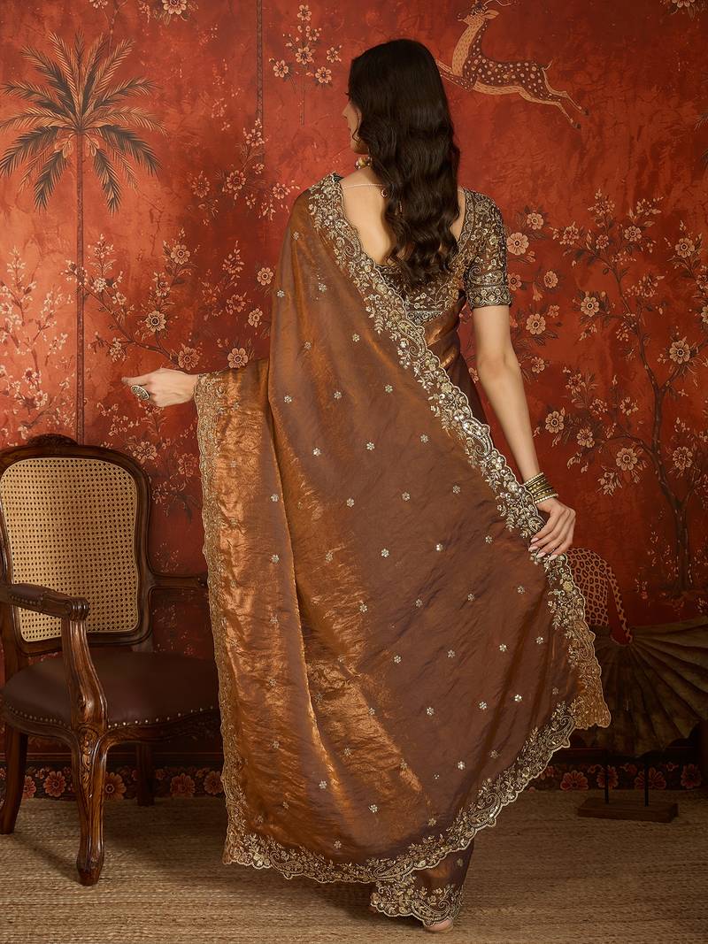 Brown tissue satin embroidered saree with unstitched blouse piece.