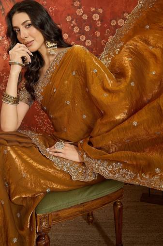 Gold tissue satin embroidered saree with unstitched blouse piece.